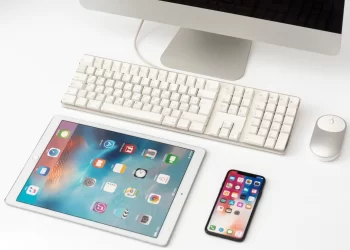 Digital nomad's essential tools: tablet, keyboard, and cell phone.