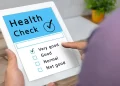 A digital nomad holding a tablet with a check mark on it for fitness tips.