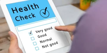 A digital nomad holding a tablet with a check mark on it for fitness tips.