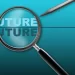 The word future magnified by a magnified glass, and the surface also contains a digital pen.