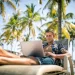 Digital nomad working at a beachside cafe